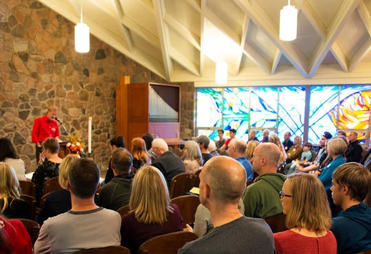 People listening to speaker in Grebel Chapel