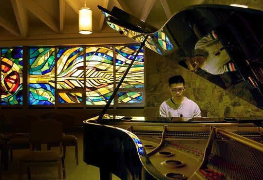 Nicholas plays the piano in the Grebel chapel