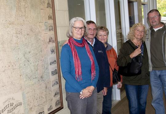 Archivist-Librarian Laureen  Harder-Gissing with Rene and Sandy  Eby, and Lynda and Kim Eby in front of Tremaine Map.