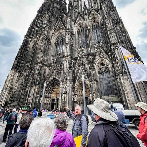 Troy Osborne with alumni and friends outside a cathedral in Europe