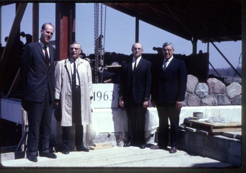 L-R John Neufeld , Milton R.Good, J. Winifield Fretz, Elven Shantz laying cornerstone at grebel build site