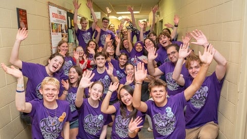 students wave excitedly