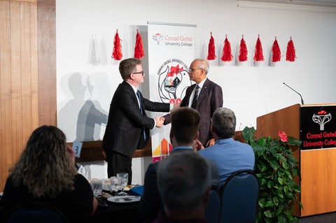 Marcus Shantz shakes Vivek Goel's hand during the 60th gala