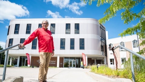 Fred W Martin stands outside of Grebel