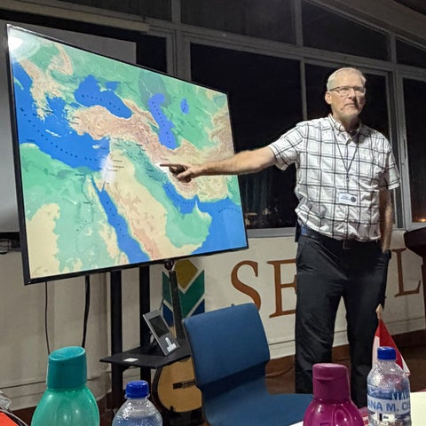 Derek Suderman pointing at a map