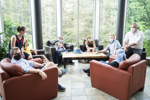 staff and grads sitting in the atrium