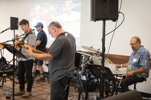 four alumni playing instruments 