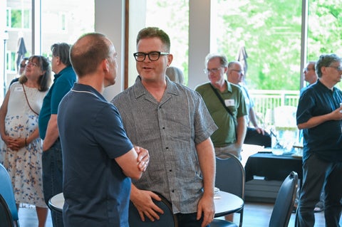 Marcus talks to an alumni in the Grebel dining room
