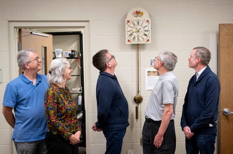 Troy Osborne, Laureen Harder-Gissing, Marcus Shantz, Bert Friesen, Kenneth Friesen, looking at the Mennonite wall clock