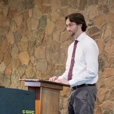 Ben Hollingsworth standing at a podium 