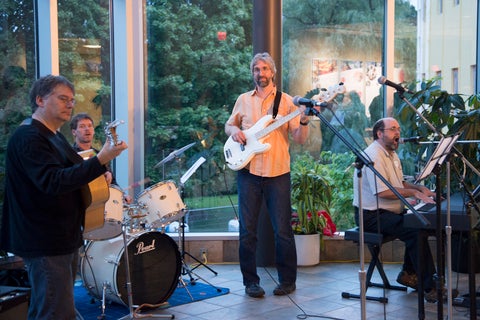 a band of grebel alumni play instruments in the atrium