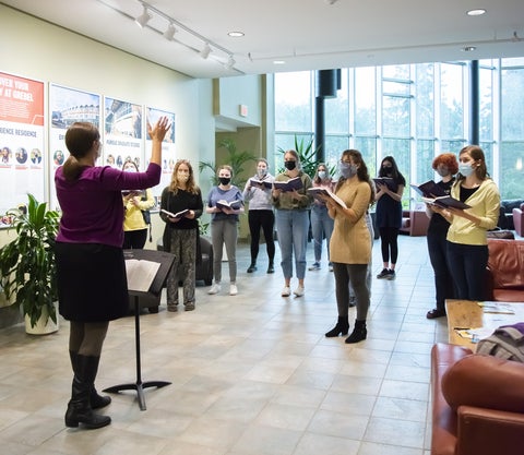 choir singing in masks in atrium 