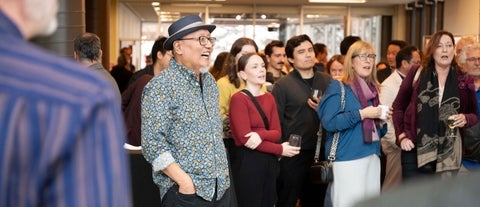 Dr. Tom Lee among crowd looking off camera 