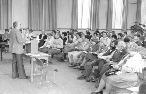 Ralph Lebold speaking infront of a full classroom 