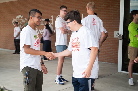 two students shaking hands