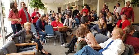 Grebel staff and faculty gathered at a coffee break sharing a laugh