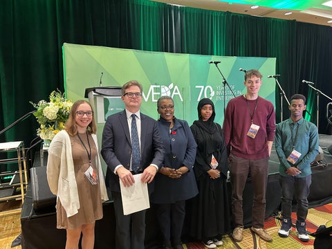 students and the president of Grebel and Board member posing at Meda
