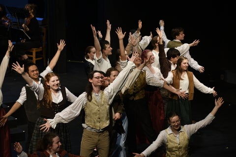 Cast of Something Rotten, with all of their arms raised at the end of a song.