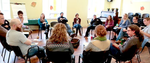 group of people sitting in a circle 