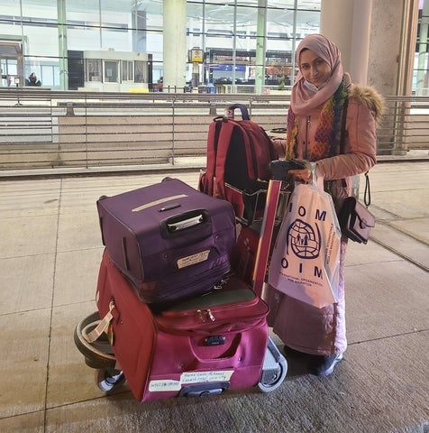 Remma standing with cart full of luggage 