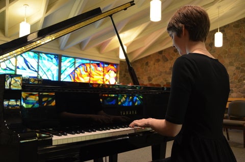 Nicole Simone in the Grebel chapel playing piano