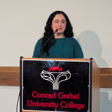 Elizabeth Ahing standing at a podium 