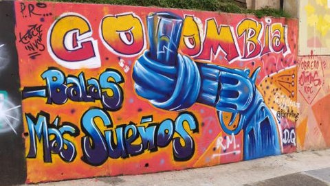 Grafitti that says Colombia, with a gun nozzel tied in a knot