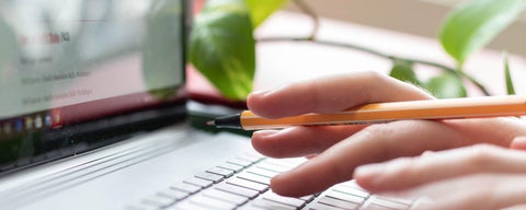 Close up of fingers typing on laptop keyboard