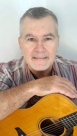 Henry posing with a guitar