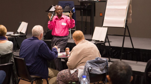 Issa Ebombolo speaking to a group
