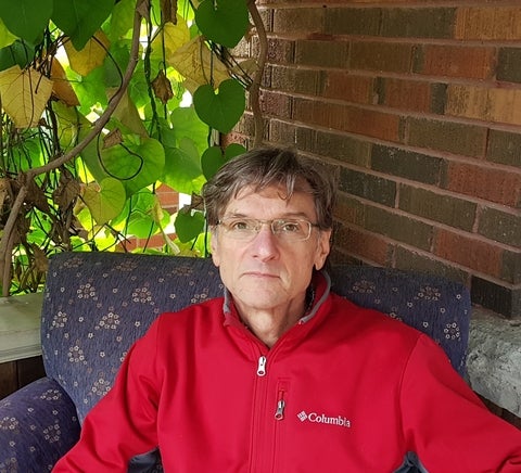 kevin ranney sitting in a chair 