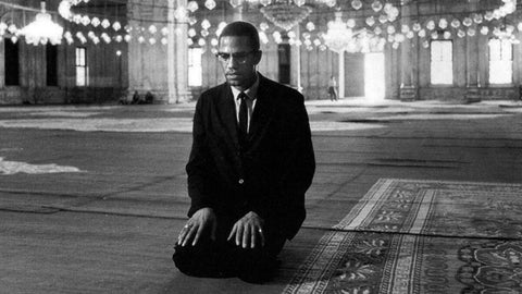 malcom X kneeling on the floor