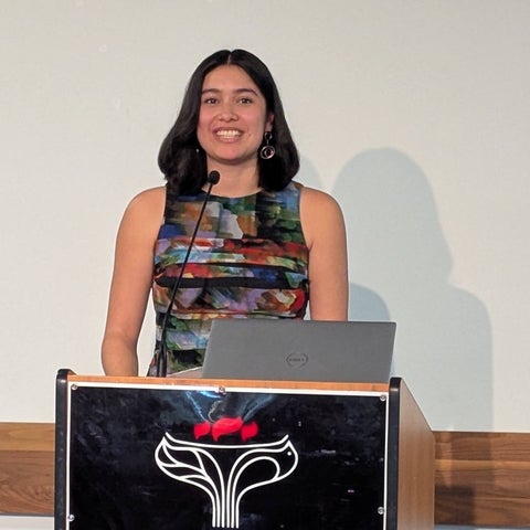 Maya Valdez speaking at a podium 