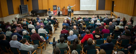 A crowd listens to film maker Paul Plett in the great hall during a bechtel lecture. 