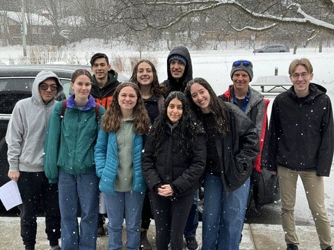 Group of students outside in the snow, about to depart on the MDS trip