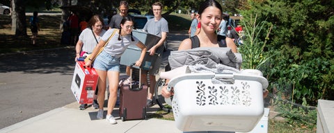 New Grebel students carrying their belongings into residence building