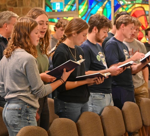 Students singing in chapel