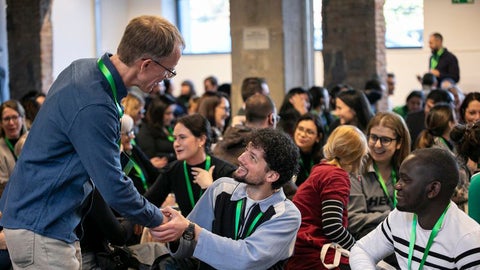 Paul Heidebrecht shaking hands with the audience