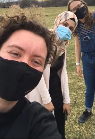 remma and two friends posing while wearing face masks 