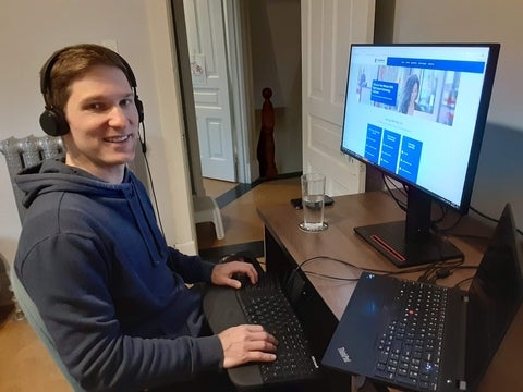 Scott sitting at desk with computer 