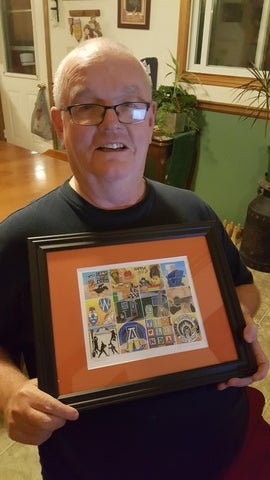 tim oconnor holding a picture frame 
