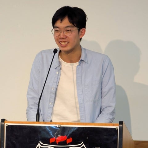 Timothy Khoo speaking at a podium 