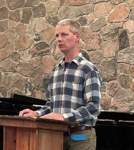 Chaplain standing at podium in Chapel
