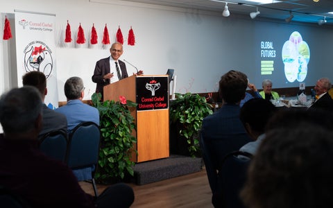 Vivek Goel speaking at a podium