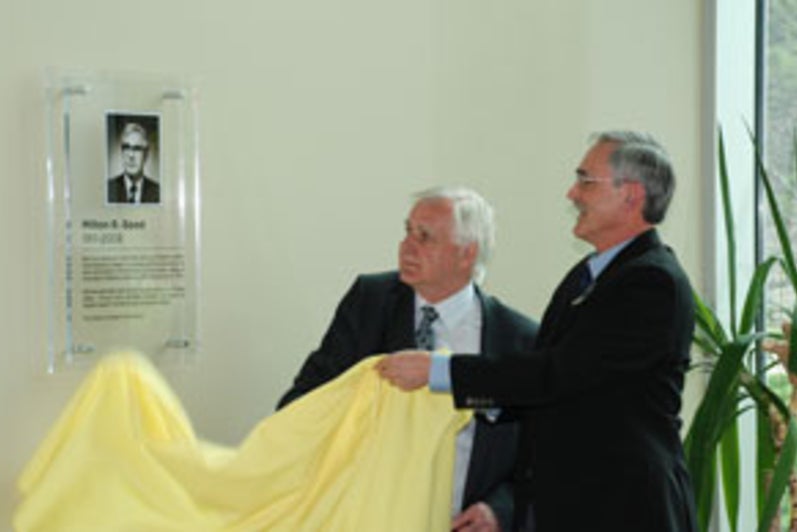 Jim Good and Henry Paetkau unveil the plaque naming the library in Milton Good's honour