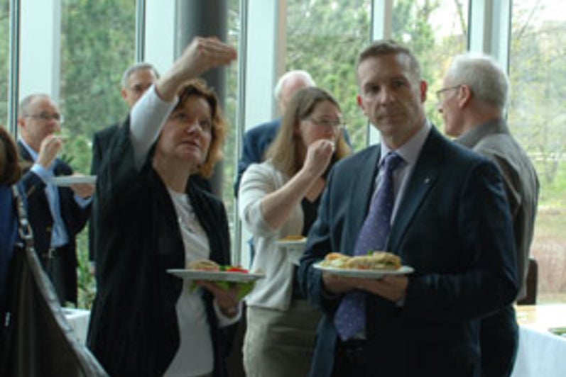 Dr. Marlene Epp explains the new entry to the archives to Member of Parliament, Peter Braid.