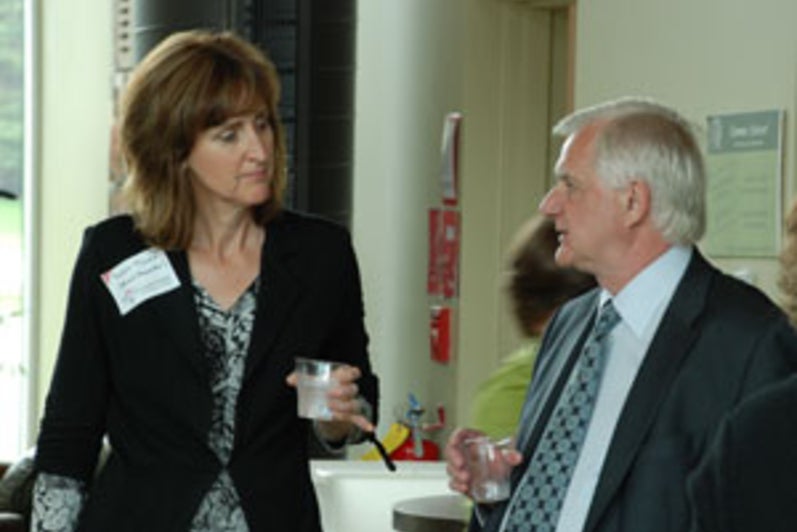 Board Chair elect Susan Taves chats with former board chair, Jim Good