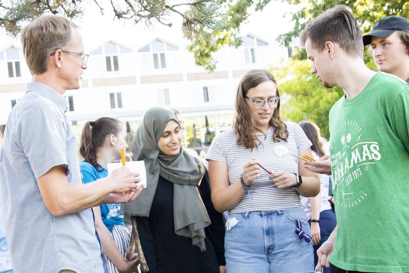 students standing and talking together outside