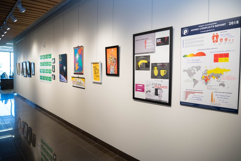 A wall of the Grebel Gallery, with serveral posters depicting peace movements.