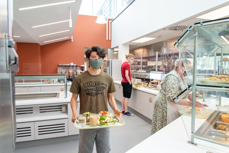 a student goes through the new serving area with a tray of food